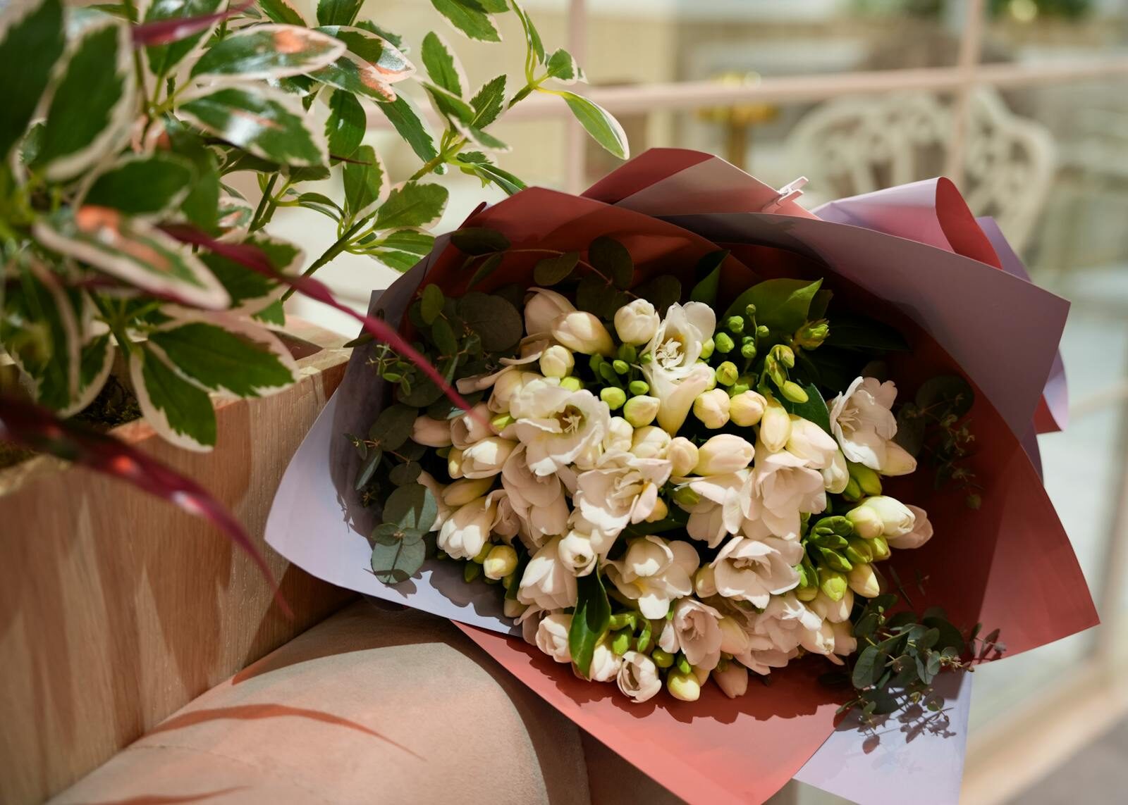 Beautiful white floral bouquet elegantly arranged with fresh greenery in a vibrant setting.