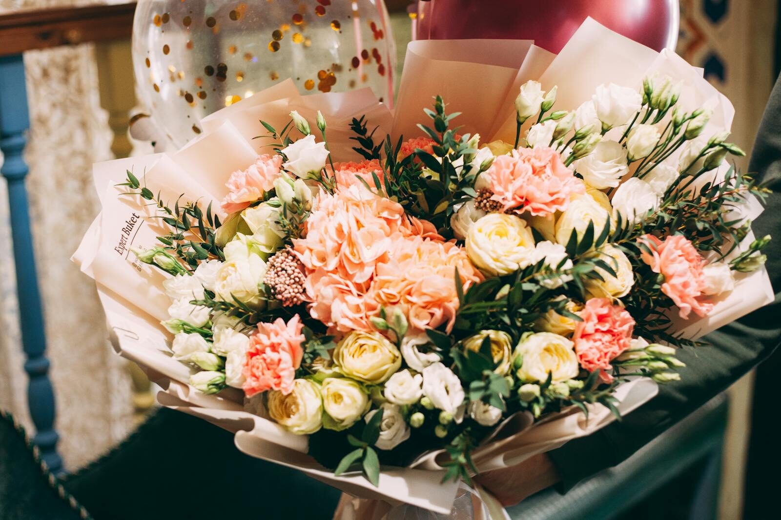 Beautiful close-up of a vibrant flower bouquet featuring roses and carnations, perfect for celebrations.